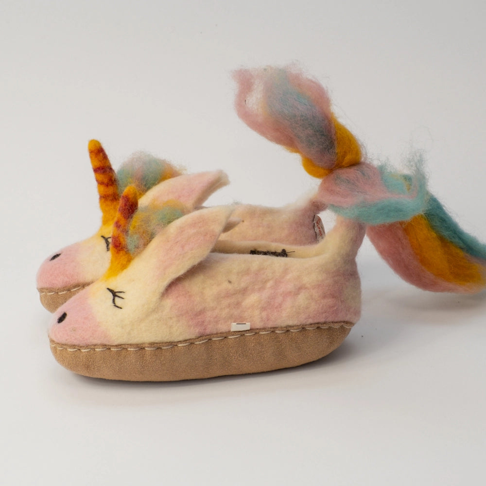 Einhorn Unicorn Filzpantoffeln Halbschuh Kinder, weiß rosa gelb hellblau mit gefransten Schwanz, gelb rot geringeltes Horn, verträumtes Gesicht, hochgezogener Wildedersohle Marke: MAUSSCHUH by MotherEarth-Munich Ansicht: Seite